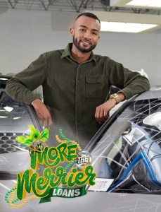 Young man posing next to his brand-new car with a First Citizens auto loan.