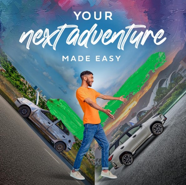 Happy young man pointing at his brand-new vehicle purchased with a first citizens auto loan. 